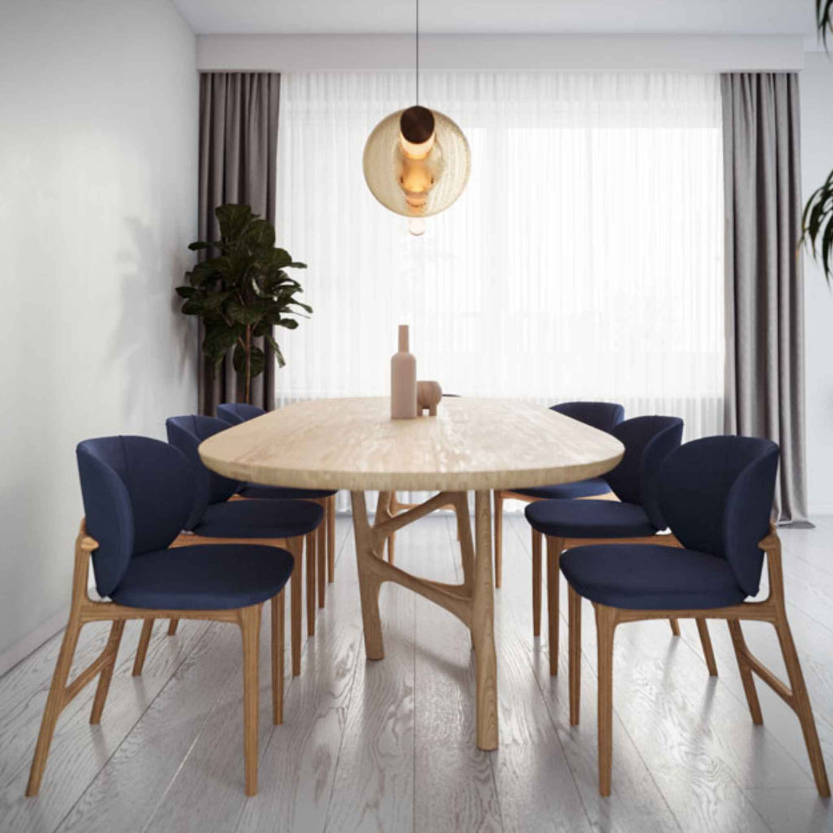 Interior setting with chairs and the Oval Dom table with a beautiful base, made from solid oak wood