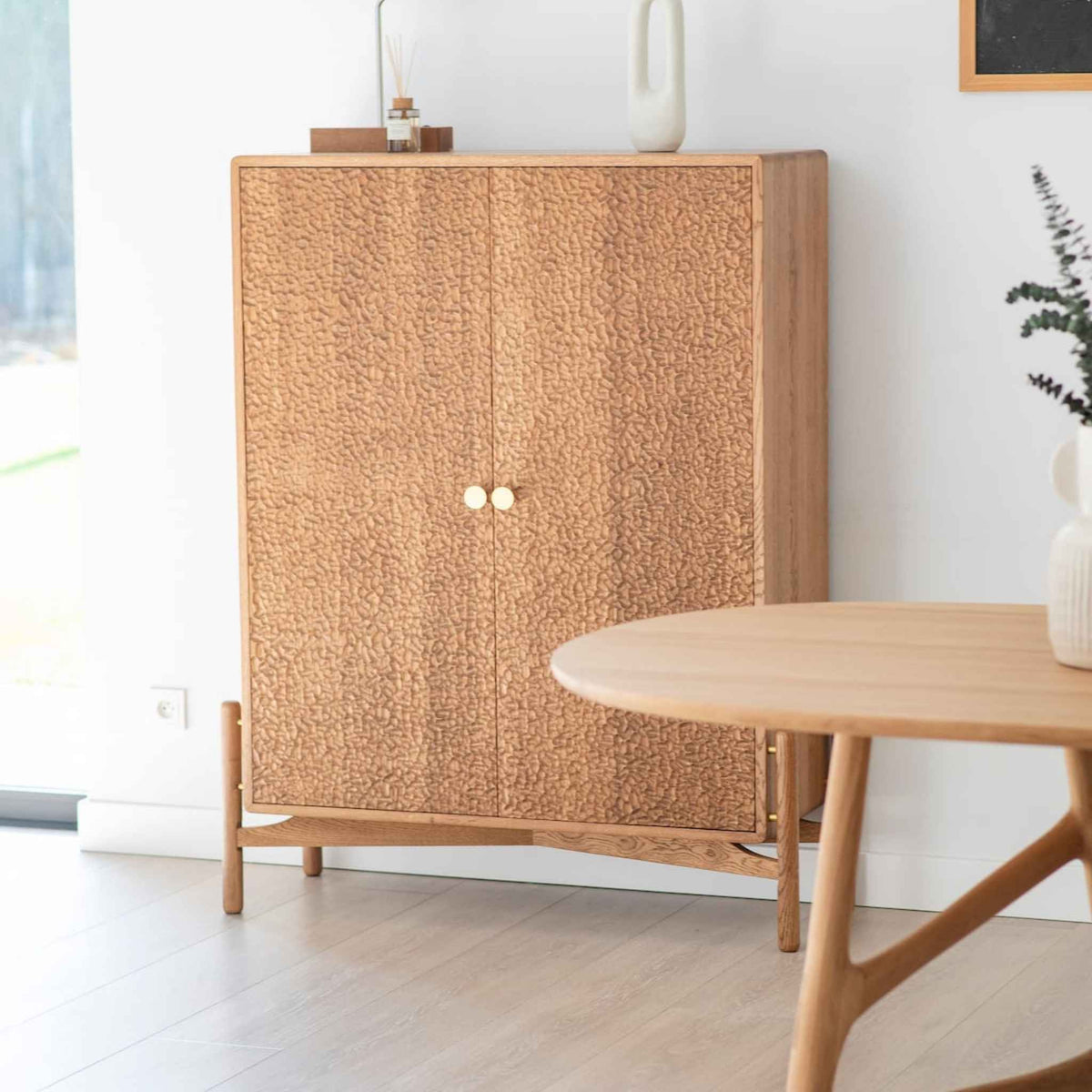 Interior arrangement with the ÉTAUDORÉ Areuse highboard and Dom table, made to order from solid oak wood