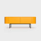 Curved Desiva Enna 01 lowboard in orange color steel, available in Switzerland via ÉTAUDORÉ