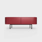 Curved Desiva Enna 01 lowboard in ruby red color steel, available in Switzerland via ÉTAUDORÉ