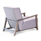 ÉTAUDORÉ Reuss armchair back angle view showing sculptural solid beech wood frame and softly upholstered lounge seat.