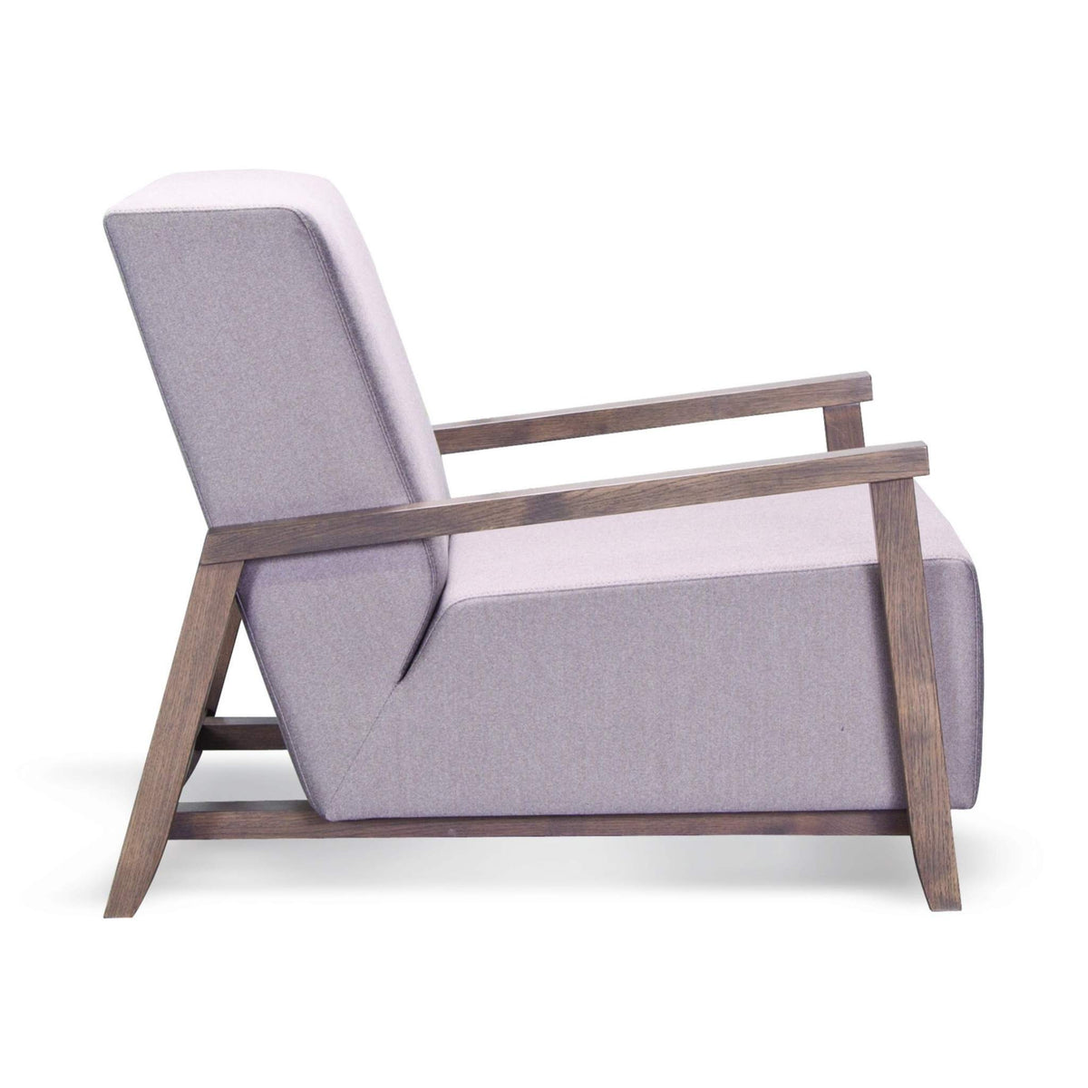 Side profile of ÉTAUDORÉ Reuss armchair highlighting relaxed reclined backrest and architectural beech wood base.